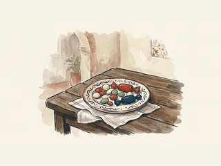 Un plato de cerámica contiene dulces ficticios y dos caramelos con envoltorios lisos.
